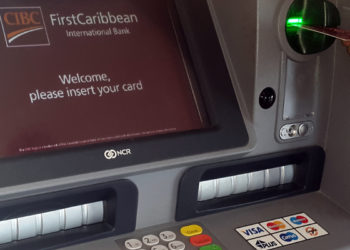 Image: Male habd shown using FCIB ATM in Barbados