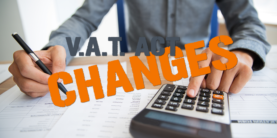 Man in background calculating Taxes, text overlay says VAT Changes